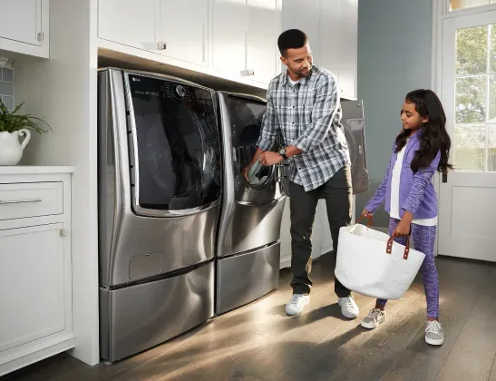 father and daughter doing laundry